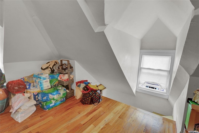 rec room featuring hardwood / wood-style flooring and vaulted ceiling