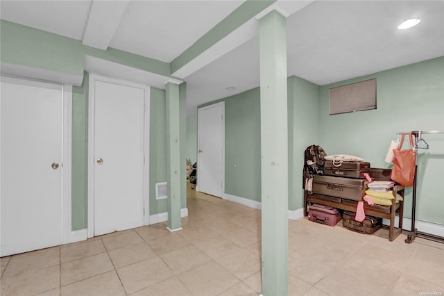 basement featuring light tile patterned floors