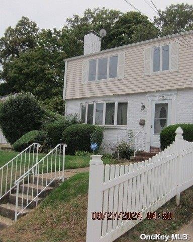 111 President St, Hempstead, NY 11550 - view of front of house featuring a chimney
