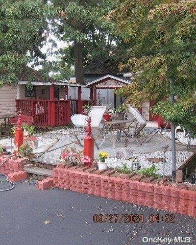 111 President St, Hempstead, NY 11550 - wooden terrace with a patio