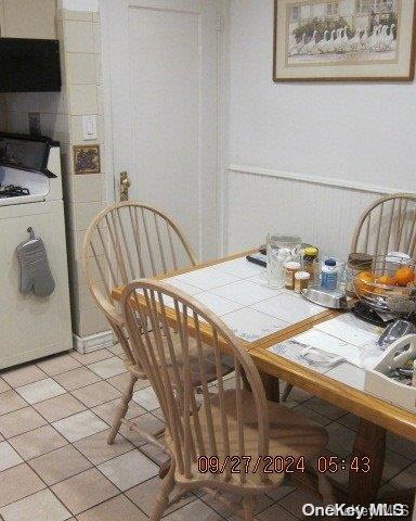 tiled dining space with washer / dryer