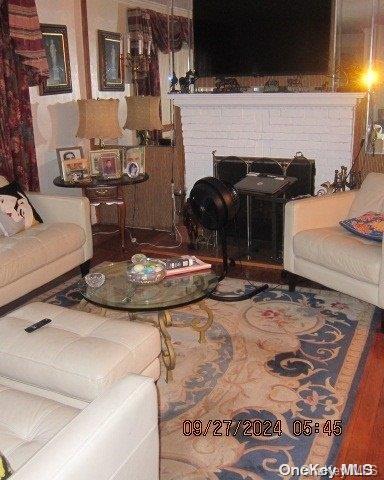 111 President St, Hempstead, NY 11550 - living area featuring a fireplace and wood finished floors