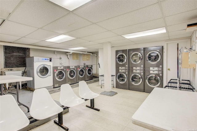 clothes washing area with stacked washer and clothes dryer and washing machine and clothes dryer