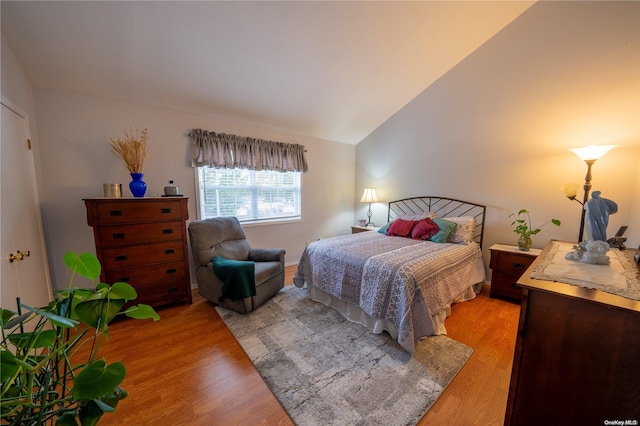 bedroom featuring vaulted ceiling and light hardwood / wood-style flooring