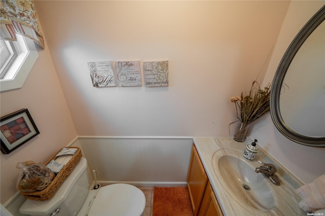 bathroom featuring tile patterned floors, vanity, and toilet