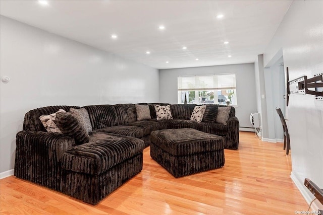 living room featuring light hardwood / wood-style flooring and a baseboard heating unit