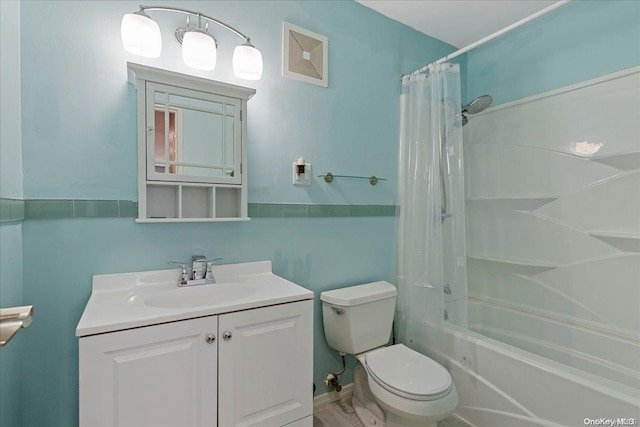 full bathroom with vanity, toilet, and shower / tub combo with curtain