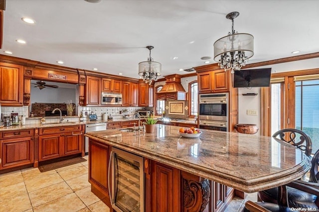 kitchen with sink, appliances with stainless steel finishes, decorative light fixtures, and an inviting chandelier