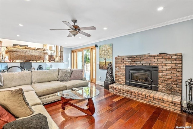 living room featuring a fireplace, hardwood / wood-style flooring, ceiling fan, and ornamental molding