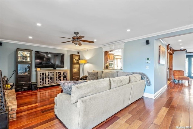 living room featuring ceiling fan, wood-type flooring, and crown molding