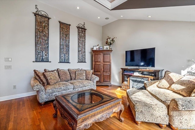 living room with hardwood / wood-style floors and lofted ceiling