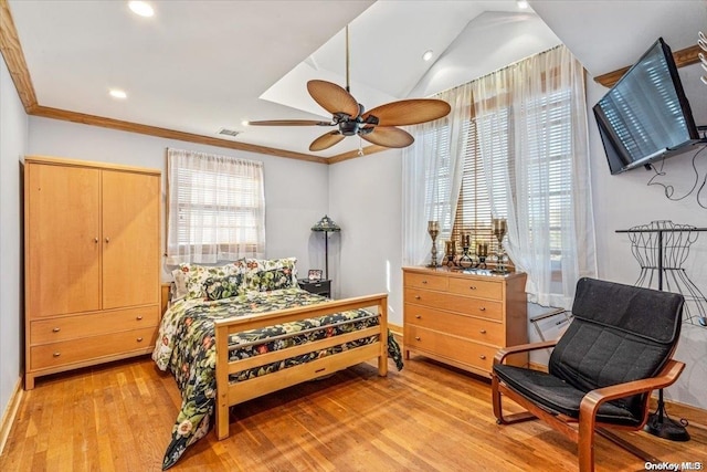 bedroom with light hardwood / wood-style floors, vaulted ceiling, ceiling fan, and crown molding