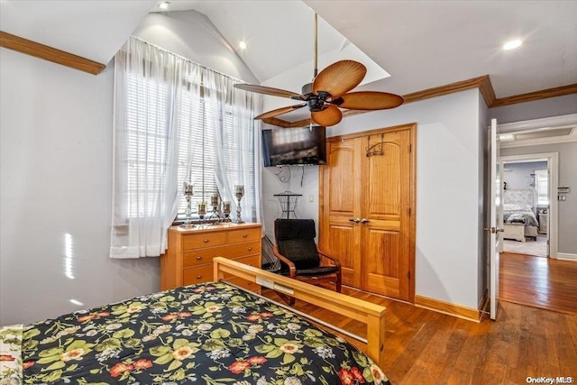 bedroom featuring ceiling fan, hardwood / wood-style floors, crown molding, and vaulted ceiling