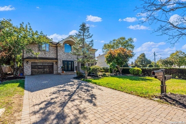 view of front of property with a garage and a front yard