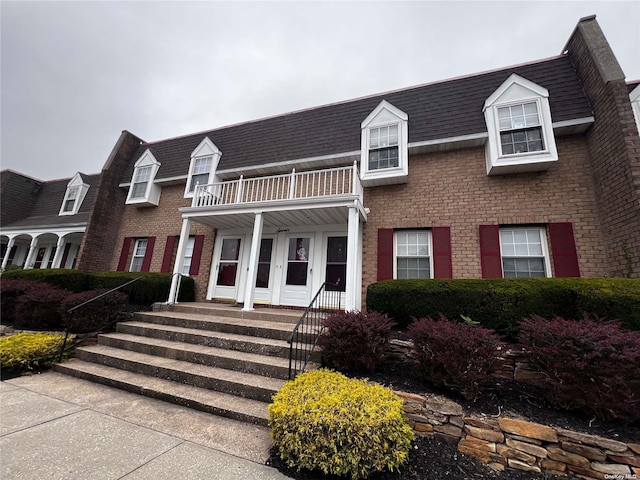 view of front of home with a balcony