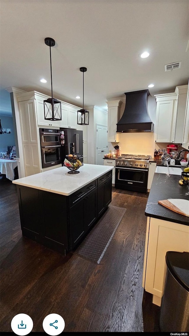 kitchen with pendant lighting, high end appliances, dark hardwood / wood-style floors, a kitchen island, and custom range hood