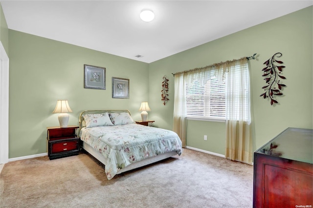 bedroom with light colored carpet