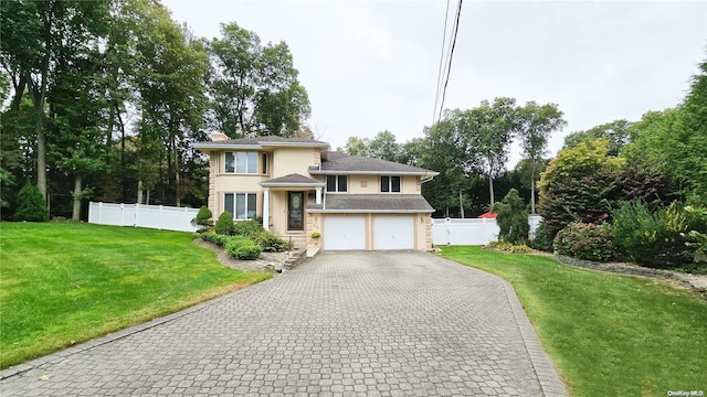 view of front of property featuring a garage and a front lawn