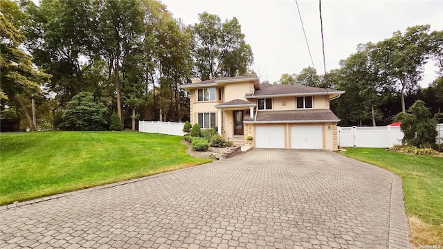 view of front of property with a front yard and a garage