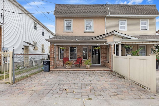 rear view of house featuring a porch