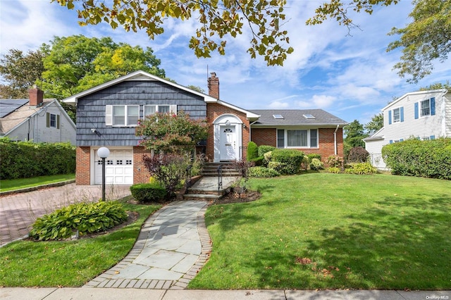 view of front of home with a garage and a front lawn