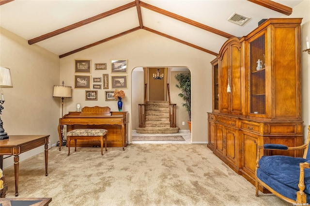 interior space with vaulted ceiling with beams and light colored carpet