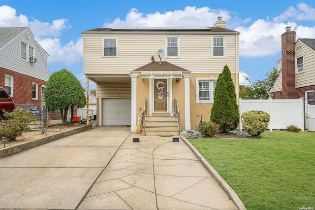 front of property with solar panels, a garage, and a front yard