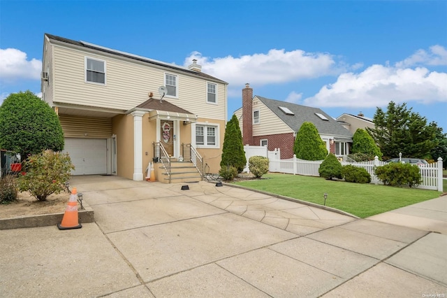 view of front of property featuring a garage and a front yard