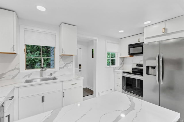 19 Oceanview Rd, Hampton Bays, NY 11946 - kitchen with appliances with stainless steel finishes, white cabinetry, backsplash, recessed lighting, and light stone countertops