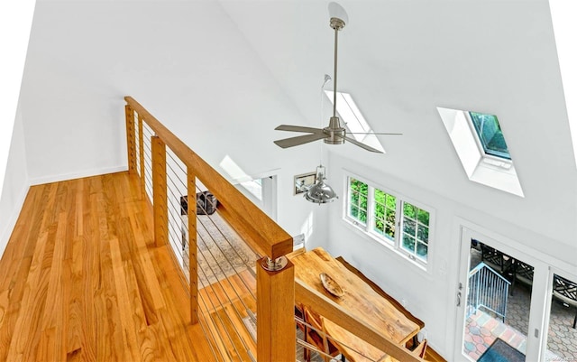 details featuring hardwood / wood-style floors, ceiling fan, and a skylight