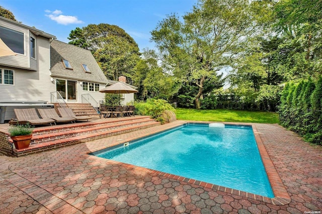 view of swimming pool featuring a patio area and a yard