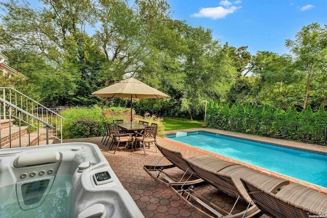 view of pool with area for grilling, a patio, and a hot tub