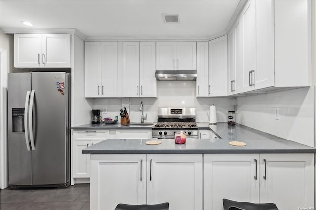 kitchen with white cabinets, sink, appliances with stainless steel finishes, and dark tile patterned flooring