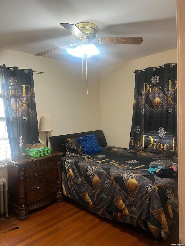 bedroom featuring ceiling fan and wood-type flooring