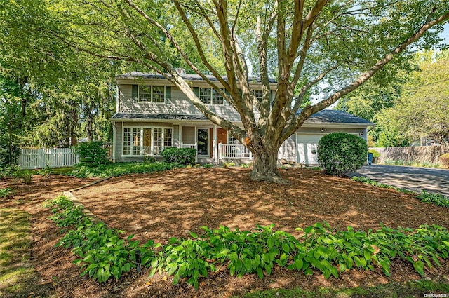 view of front property featuring covered porch and a garage