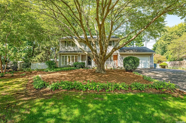 view of front of home featuring a garage and a front lawn