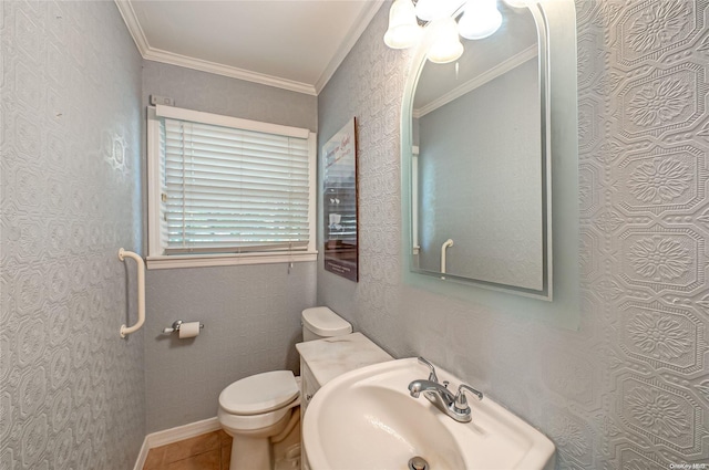 bathroom with tile patterned floors, toilet, ornamental molding, and sink