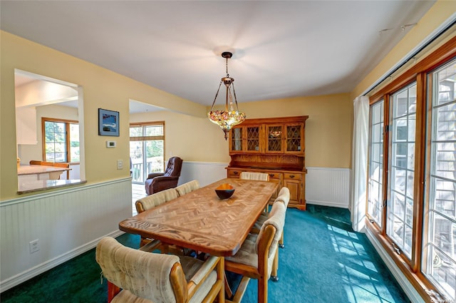 dining area with dark colored carpet and radiator heating unit