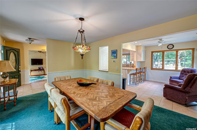 tiled dining room featuring ceiling fan