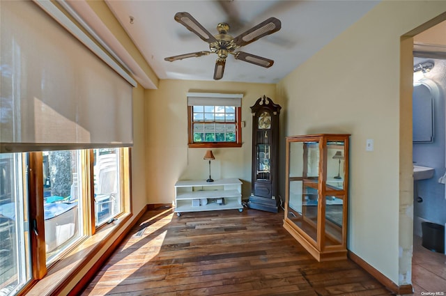 unfurnished room featuring ceiling fan and dark wood-type flooring