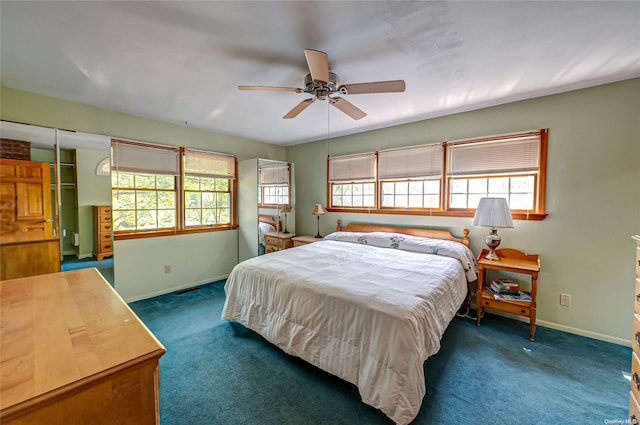 bedroom with multiple windows, ceiling fan, and dark colored carpet