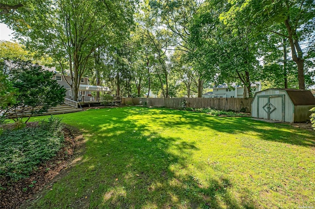 view of yard with a storage unit and a deck