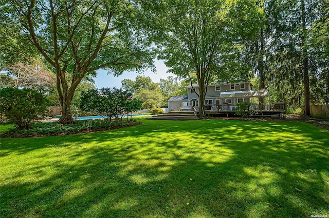 view of yard with a pool side deck