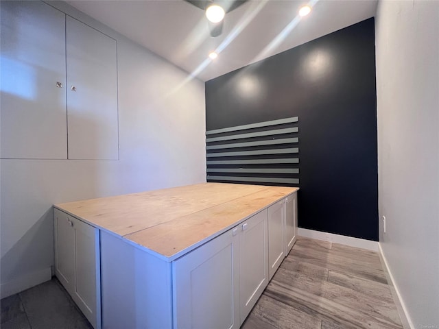 interior space with white cabinets and wooden counters