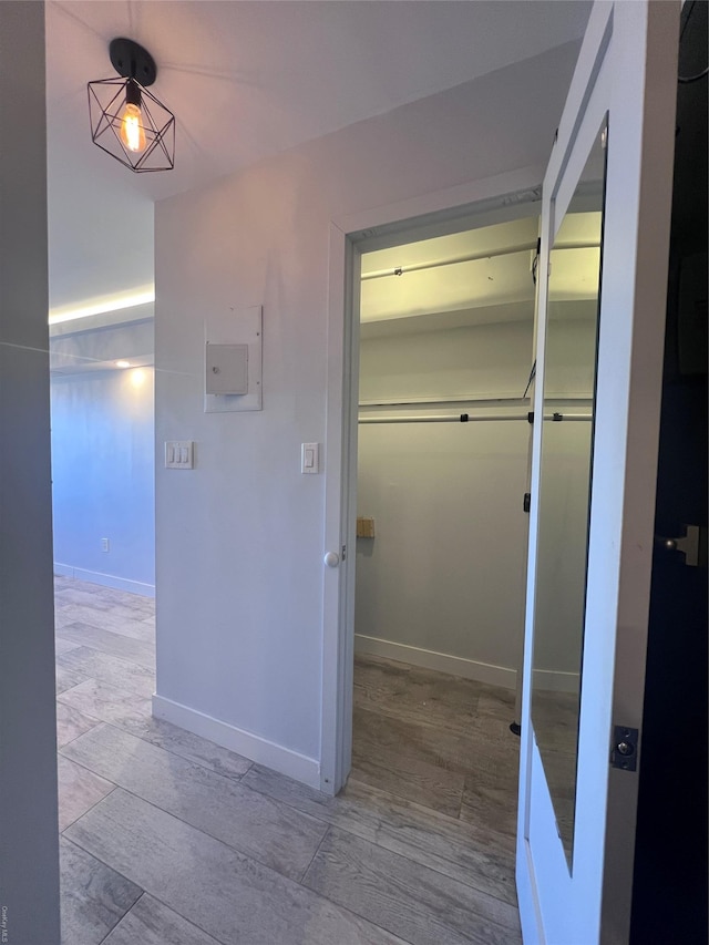 hallway with light hardwood / wood-style floors