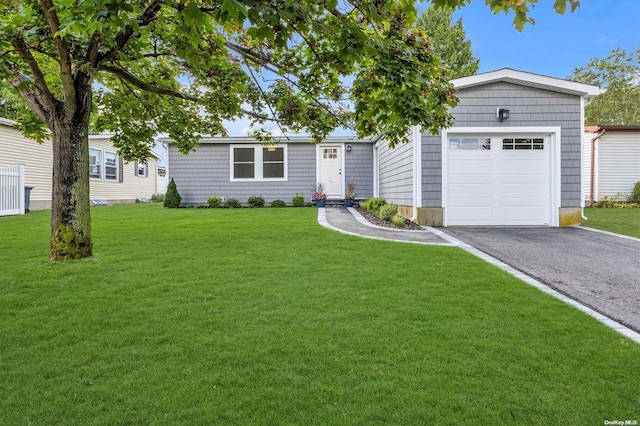 ranch-style home with a front lawn and a garage