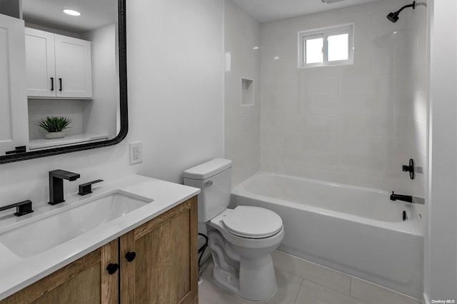 full bathroom featuring tile patterned flooring, vanity, tiled shower / bath combo, and toilet