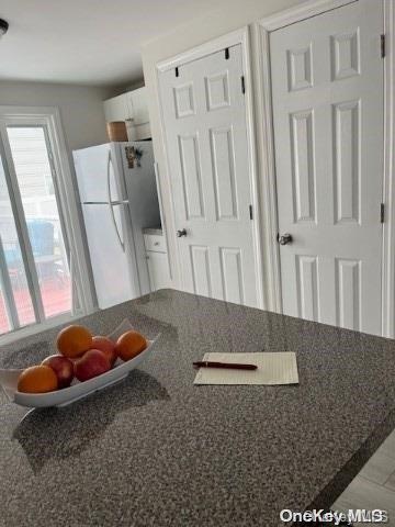 kitchen with white cabinets and white fridge