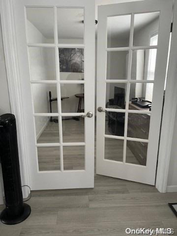 entryway featuring hardwood / wood-style floors and french doors