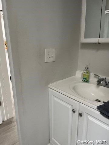 bathroom featuring hardwood / wood-style floors and vanity